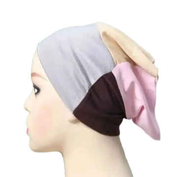 Color-blocked headscarf on a mannequin head with a blurred background