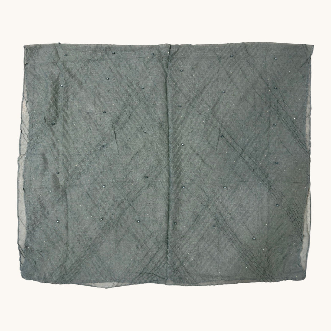 A square piece of sheer gray fabric with a subtle diamond grid pattern and small scattered bead accents, laid flat against a light cream background.