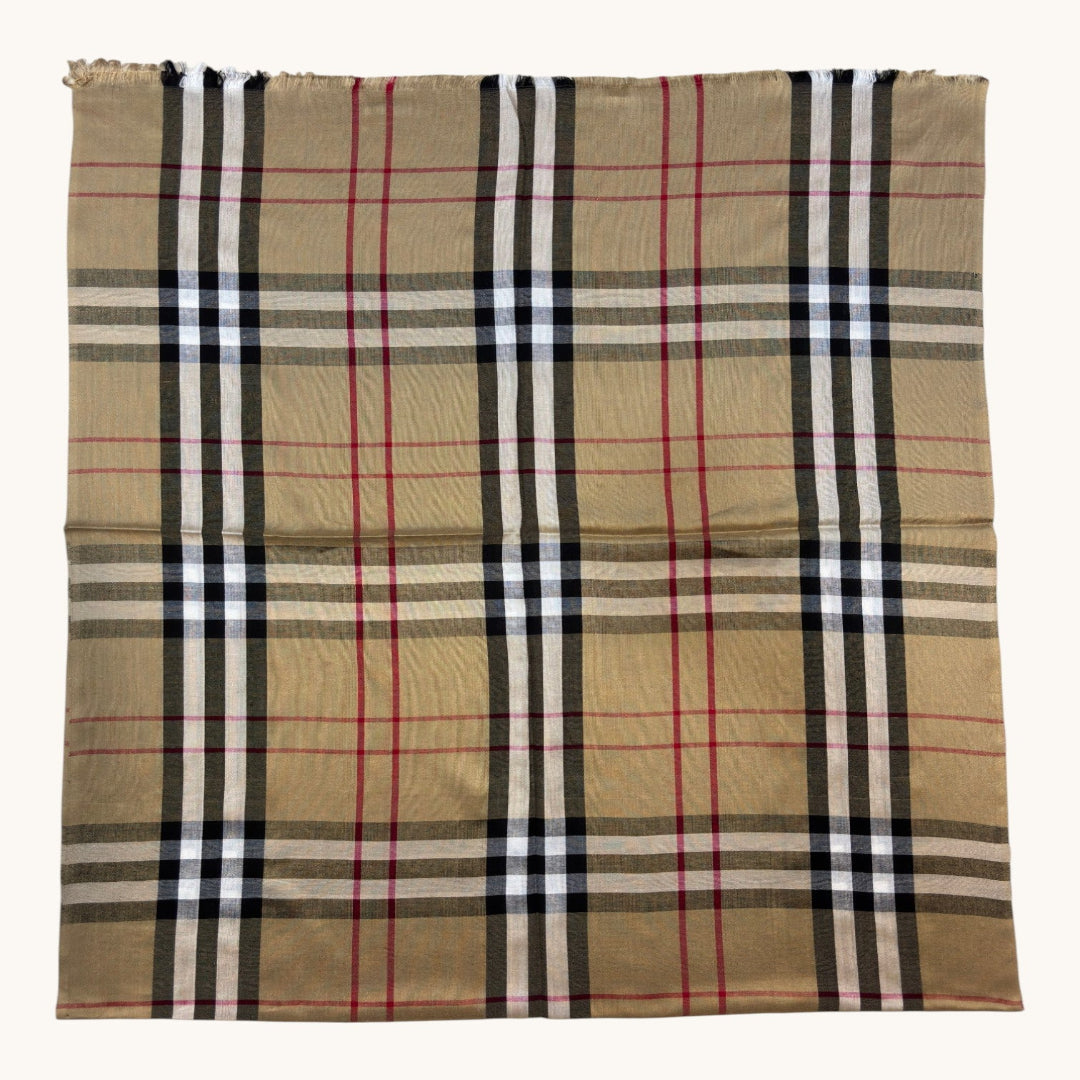 A square scarf featuring the classic vintage check plaid pattern in beige, black, white, and red, laid flat against a light off-white background.