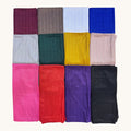 Twelve folded fabric strips in assorted colors arranged in a 3-by-4 grid on a light cream background. The colors include burgundy, taupe, light blue, royal blue, light gray, dark green, mustard yellow, blush pink, bright pink, red, purple, and black.