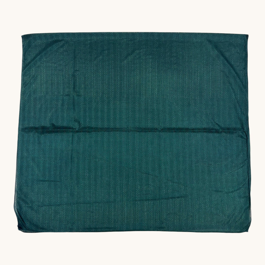 A folded dark teal-green textured fabric item, likely a blanket, towel, or sheet, displayed flat against a solid off-white background.