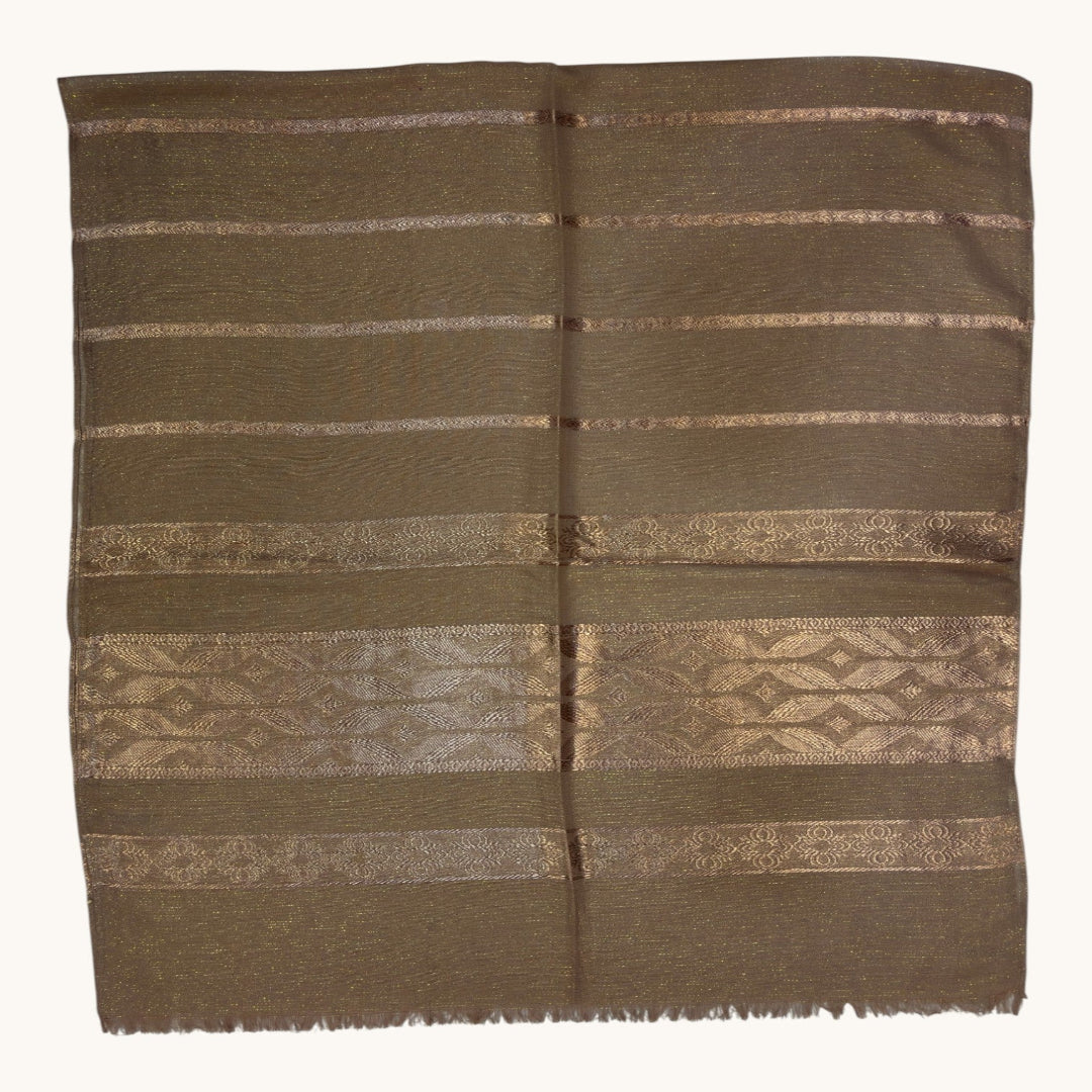 A brown woven textile, likely a traditional scarf or shawl, featuring horizontal bands of geometric and striped patterns in metallic gold and silver threads, displayed flat against a white background.