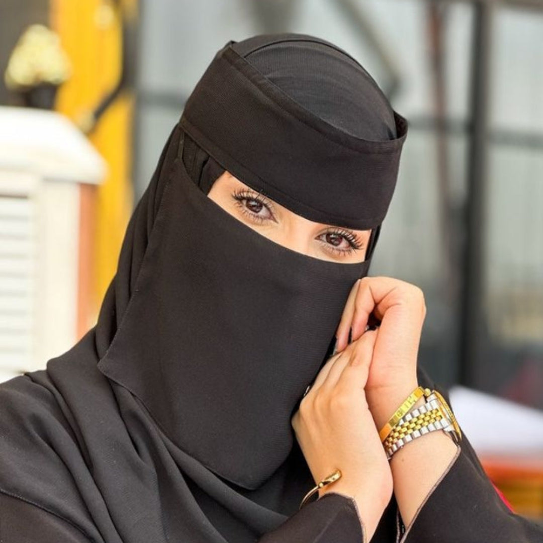 Woman wearing a black niqab with a blurred background