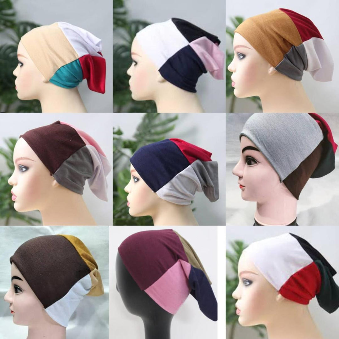 Collection of mannequin heads wearing colorful headscarves with a blurred green background.
